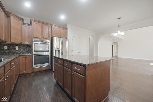 15201 Slateford Rd, Noblesville, IN 46062 - kitchen with appliances with stainless steel finishes, arched walkways, dark wood-type flooring, ornamental molding, and dark stone countertops