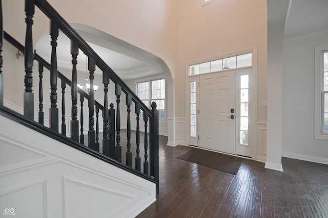 15201 Slateford Rd, Noblesville, IN 46062 - entryway with hardwood / wood-style floors, arched walkways, stairs, a decorative wall, and wainscoting