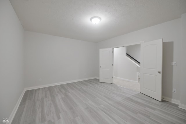 15201 Slateford Rd, Noblesville, IN 46062 - additional living space featuring light wood-style floors, a textured ceiling, and baseboards
