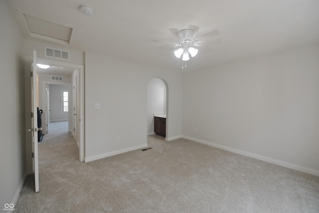 15201 Slateford Rd, Noblesville, IN 46062 - empty room with light colored carpet, ceiling fan, a smoke detector, baseboards, and arched walkways