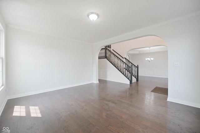 15201 Slateford Rd, Noblesville, IN 46062 - empty room featuring arched walkways, stairway, wood finished floors, a chandelier, and ornamental molding