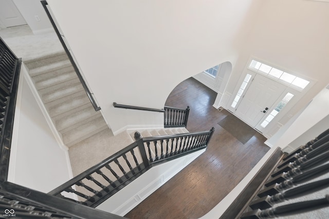 15201 Slateford Rd, Noblesville, IN 46062 - foyer entrance featuring a high ceiling, arched walkways, wood finished floors, and stairs