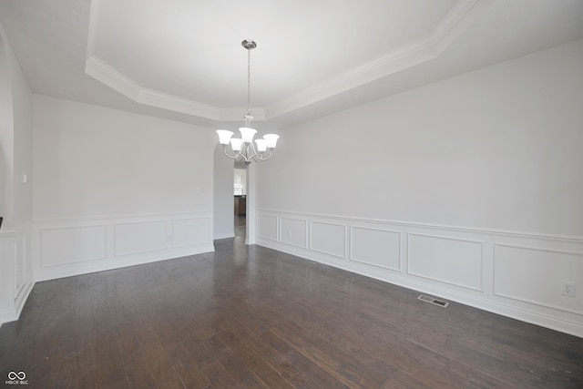 15201 Slateford Rd, Noblesville, IN 46062 - empty room with a raised ceiling, a chandelier, dark wood-style floors, a decorative wall, and ornamental molding