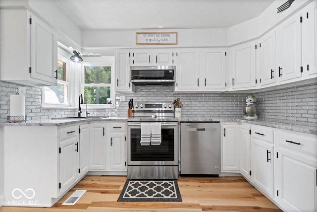 3459 E 650 N, Windfall, IN 46076 - kitchen featuring stainless steel appliances, white cabinetry, and backsplash