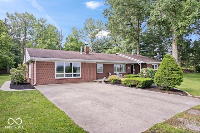 3459 E 650 N, Windfall, IN 46076 - ranch-style home with brick siding, driveway, a front lawn, a chimney, and a patio