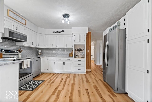 3459 E 650 N, Windfall, IN 46076 - kitchen featuring appliances with stainless steel finishes, light wood-style floors, and white cabinetry