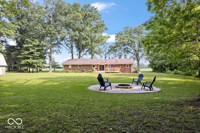 3459 E 650 N, Windfall, IN 46076 - view of grassy yard featuring a fire pit and a deck