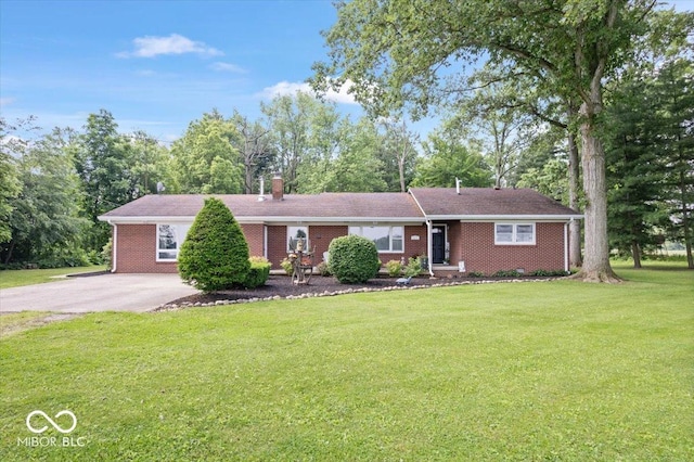 3459 E 650 N, Windfall, IN 46076 - ranch-style home with a chimney, a front yard, brick siding, driveway, and view of wooded area