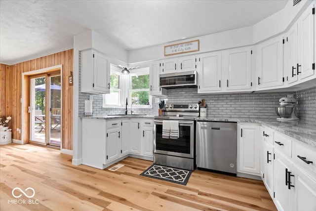 3459 E 650 N, Windfall, IN 46076 - kitchen featuring stainless steel appliances, decorative backsplash, plenty of natural light, white cabinetry, and a textured ceiling
