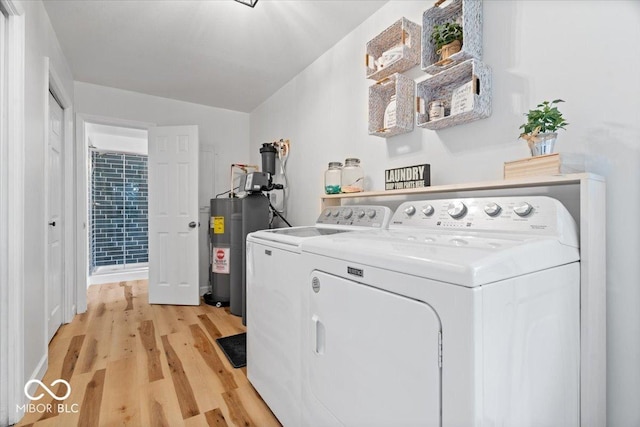 3459 E 650 N, Windfall, IN 46076 - laundry area featuring washer and clothes dryer, light wood-type flooring, and water heater