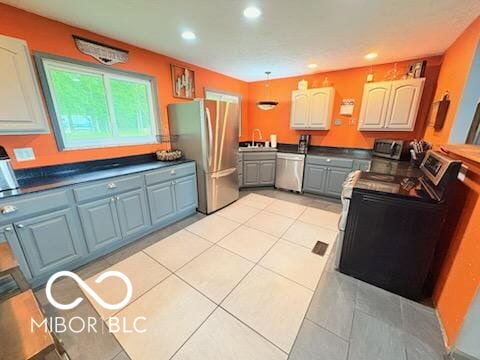 8990 N 850 W, Fairland, IN 46126 - kitchen with stainless steel appliances, recessed lighting, light tile patterned floors, a sink, and dark countertops