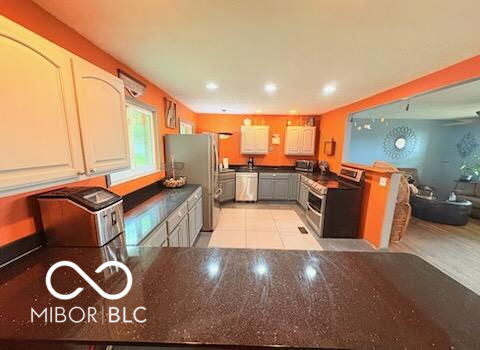 8990 N 850 W, Fairland, IN 46126 - kitchen featuring appliances with stainless steel finishes, dark countertops, recessed lighting, and a peninsula