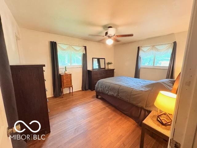 8990 N 850 W, Fairland, IN 46126 - bedroom with light wood-type flooring, multiple windows, and a ceiling fan