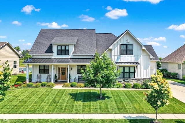 6882 Bladstone Rd, Noblesville, IN 46062 - modern farmhouse with board and batten siding, a standing seam roof, and roof with shingles