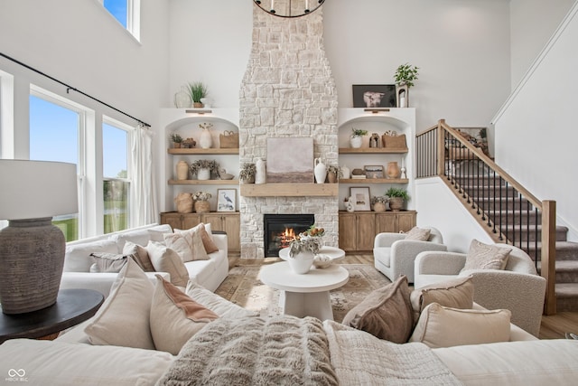 19652 Shadow Trace Path, Westfield, IN 46074 - living area featuring wood finished floors, a high ceiling, plenty of natural light, a fireplace, and stairway