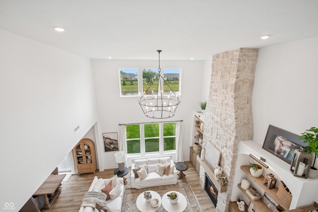 19652 Shadow Trace Path, Westfield, IN 46074 - living room with a chandelier, healthy amount of natural light, light wood-style flooring, a high ceiling, and recessed lighting