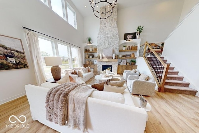 19652 Shadow Trace Path, Westfield, IN 46074 - living area with a high ceiling, healthy amount of natural light, a chandelier, light wood-type flooring, and baseboards