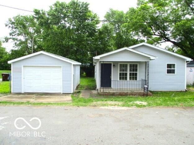 620 S 2nd St, Noblesville, IN 46060 - view of front of home featuring a porch, a garage, driveway, and an outdoor structure