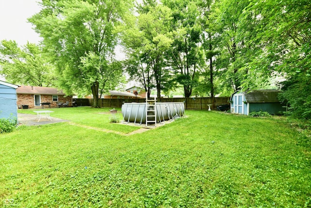 1445 Biloxi Ln, Beech Grove, IN 46107 - fenced backyard featuring a storage shed and a patio area