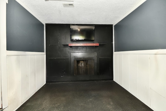 1445 Biloxi Ln, Beech Grove, IN 46107 - unfurnished living room featuring a fireplace, a textured ceiling, and a wainscoted wall