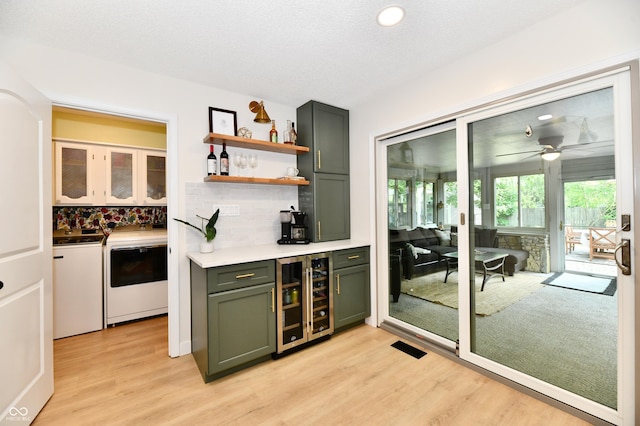 7242 Highburry Dr, Indianapolis, IN 46256 - indoor dry bar featuring wine cooler, washing machine and dryer, backsplash, light wood-style flooring, and recessed lighting