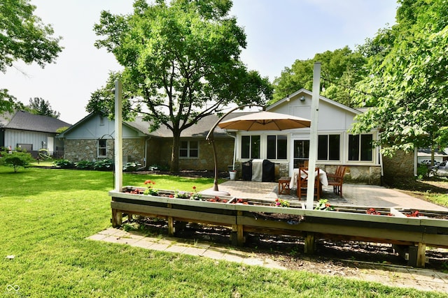 7242 Highburry Dr, Indianapolis, IN 46256 - rear view of property with stone siding, a lawn, and a patio area