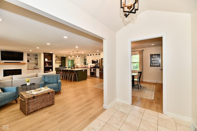 7242 Highburry Dr, Indianapolis, IN 46256 - living area featuring recessed lighting, a chandelier, light wood finished floors, and a fireplace