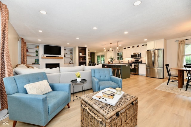 7242 Highburry Dr, Indianapolis, IN 46256 - living area with recessed lighting, light wood-type flooring, and a fireplace