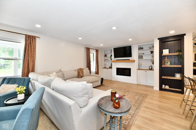 7242 Highburry Dr, Indianapolis, IN 46256 - living area featuring light wood-style floors, a fireplace, and recessed lighting