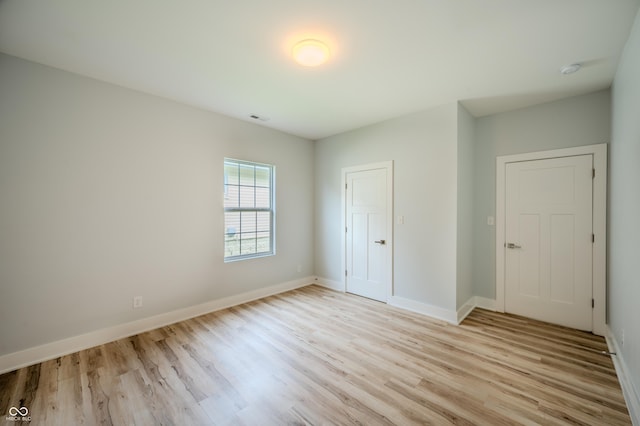 2159 W 58th St NW, Indianapolis, IN 46228 - unfurnished bedroom featuring light wood finished floors