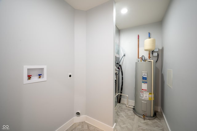 2159 W 58th St NW, Indianapolis, IN 46228 - washroom featuring hookup for an electric dryer, water heater, and washer hookup