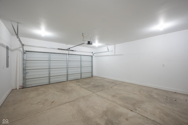 2159 W 58th St NW, Indianapolis, IN 46228 - garage with baseboards and a garage door opener