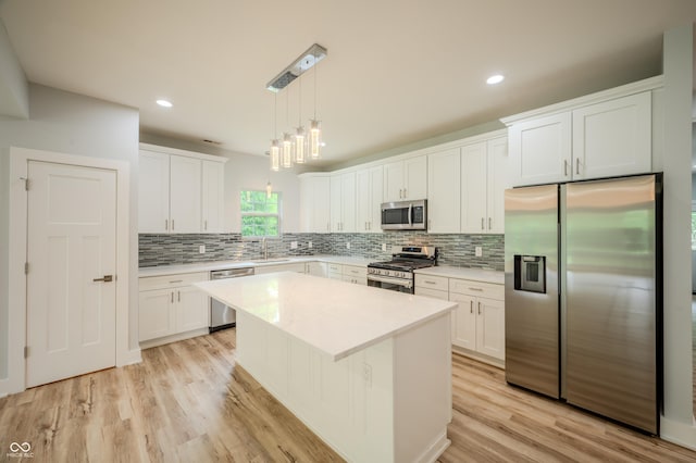 2159 W 58th St NW, Indianapolis, IN 46228 - kitchen with stainless steel appliances, backsplash, light countertops, white cabinets, and recessed lighting