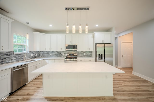 2159 W 58th St NW, Indianapolis, IN 46228 - kitchen featuring appliances with stainless steel finishes, a center island, backsplash, white cabinets, and recessed lighting