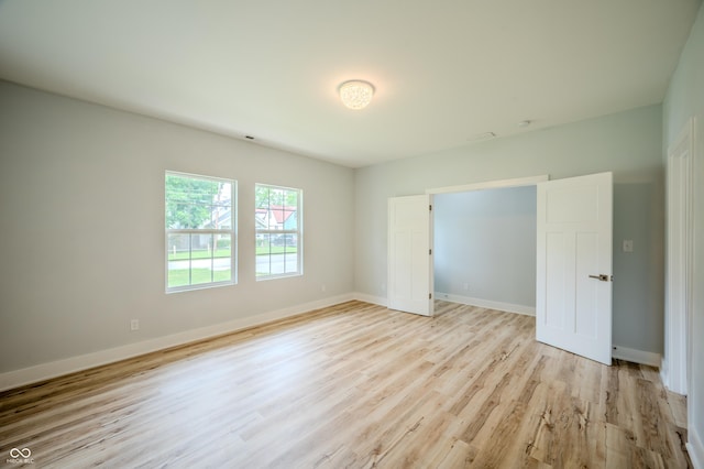 2159 W 58th St NW, Indianapolis, IN 46228 - unfurnished bedroom with light wood finished floors and baseboards