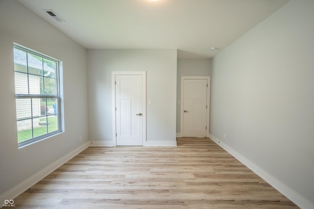 2159 W 58th St NW, Indianapolis, IN 46228 - unfurnished bedroom with light wood finished floors and baseboards