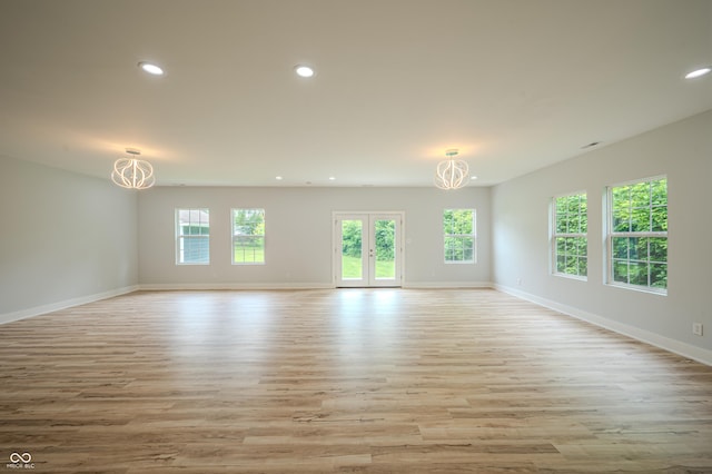 2159 W 58th St NW, Indianapolis, IN 46228 - unfurnished room with a chandelier, plenty of natural light, recessed lighting, and light wood-style floors