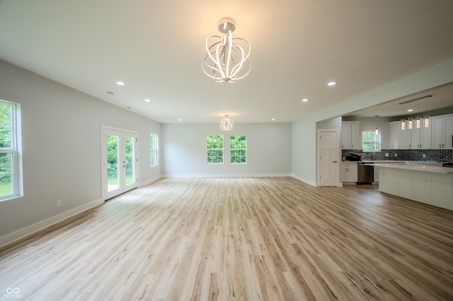 2159 W 58th St NW, Indianapolis, IN 46228 - unfurnished living room with a chandelier, recessed lighting, and light wood finished floors