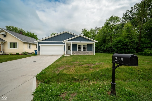 2159 W 58th St NW, Indianapolis, IN 46228 - view of front of house featuring a garage, concrete driveway, a front yard, and stone siding
