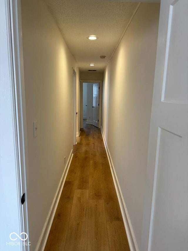 1421 S Meridian St, Indianapolis, IN 46225 - corridor with hardwood / wood-style floors, recessed lighting, baseboards, and a textured ceiling