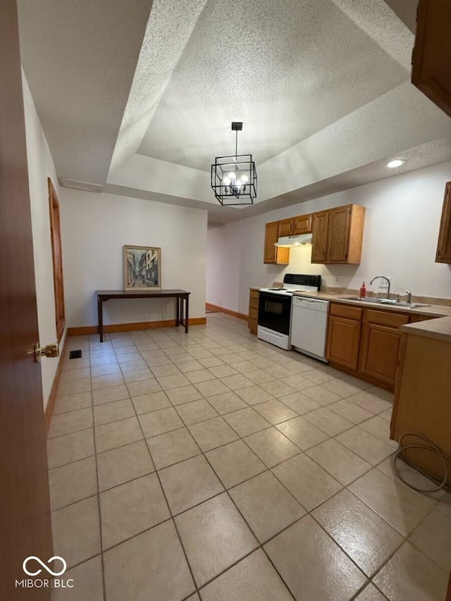 1421 S Meridian St, Indianapolis, IN 46225 - kitchen featuring white appliances, a raised ceiling, under cabinet range hood, a sink, and baseboards