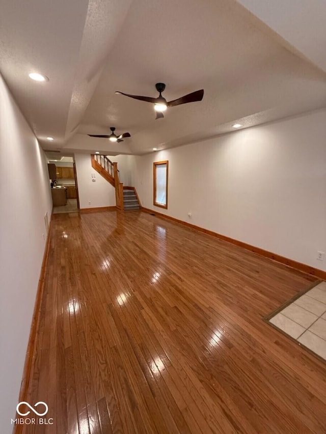 1421 S Meridian St, Indianapolis, IN 46225 - unfurnished living room featuring wood-type flooring, a ceiling fan, baseboards, and stairs