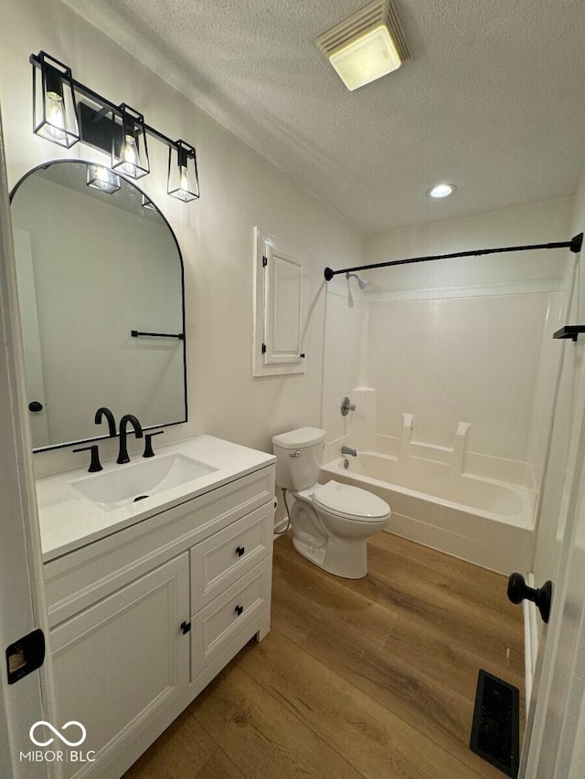 1421 S Meridian St, Indianapolis, IN 46225 - full bath featuring toilet, shower / bath combination, wood finished floors, a textured ceiling, and vanity