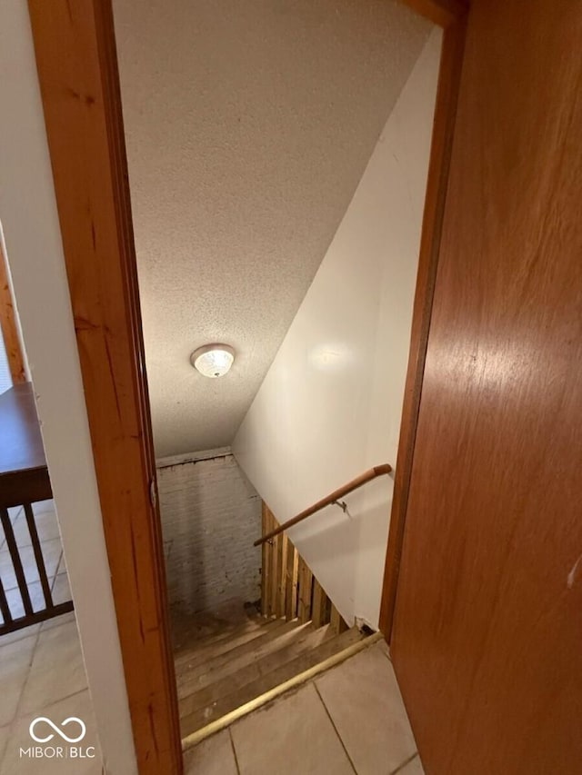 1421 S Meridian St, Indianapolis, IN 46225 - stairs featuring a textured ceiling and tile patterned flooring