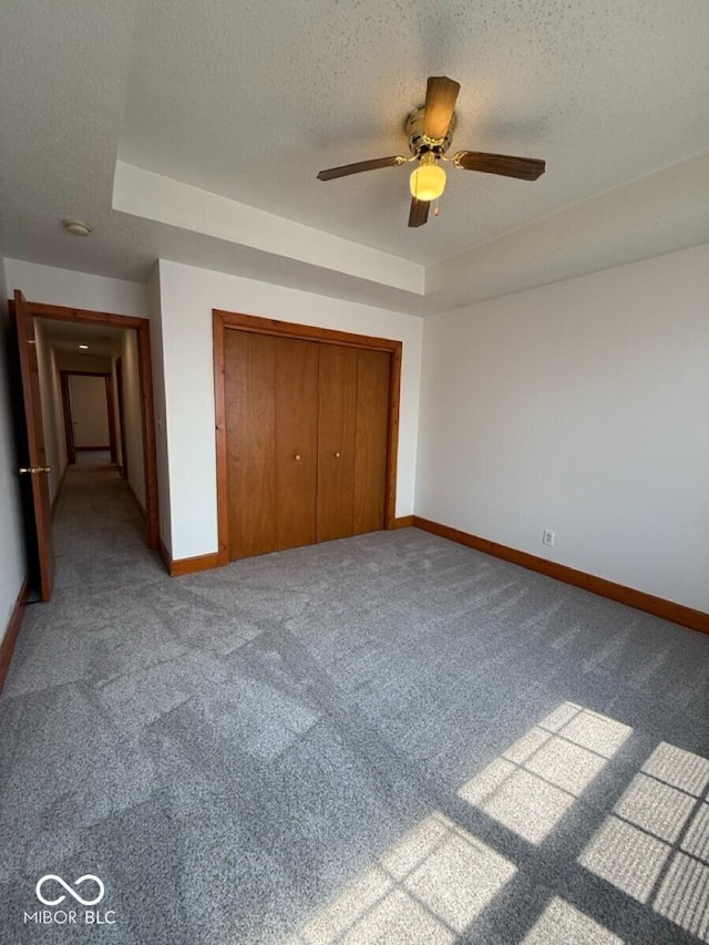 1421 S Meridian St, Indianapolis, IN 46225 - unfurnished bedroom with baseboards, carpet flooring, a textured ceiling, a closet, and a raised ceiling