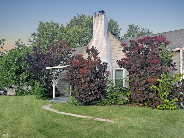 1141 N Shadeland Ave, Indianapolis, IN 46219 - view of home's exterior with a lawn and a chimney