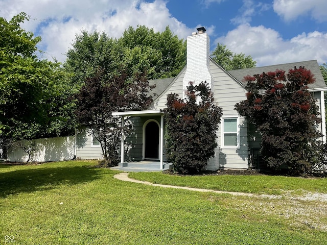 1141 N Shadeland Ave, Indianapolis, IN 46219 - obstructed view of property featuring a front lawn and a chimney
