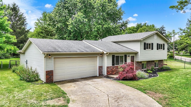 7504 Troon Ct, Indianapolis, IN 46237 - split level home featuring a garage, brick siding, roof with shingles, and concrete driveway