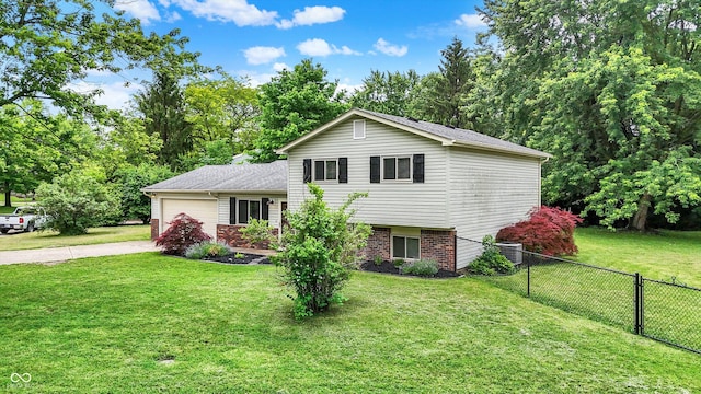 7504 Troon Ct, Indianapolis, IN 46237 - tri-level home with concrete driveway, a garage, central air condition unit, brick siding, and view of scattered trees