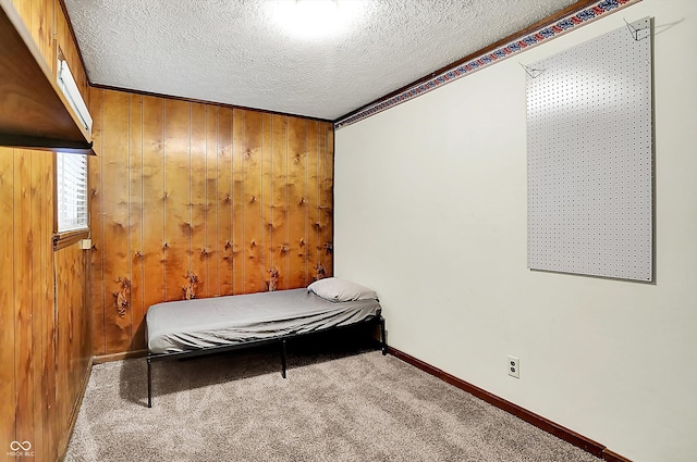 7504 Troon Ct, Indianapolis, IN 46237 - carpeted bedroom featuring a textured ceiling, wooden walls, and baseboards